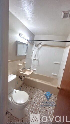 A bathroom with a toilet, sink, and bathtub.