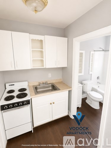 A small kitchen with white appliances and cabinets.