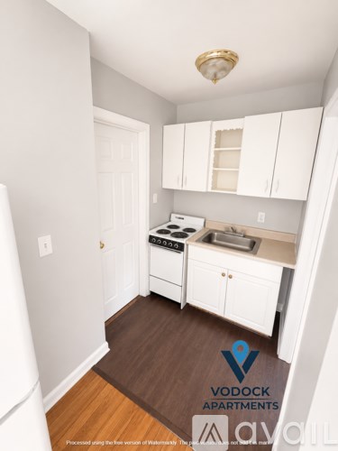 A small kitchen with white appliances and cabinets.