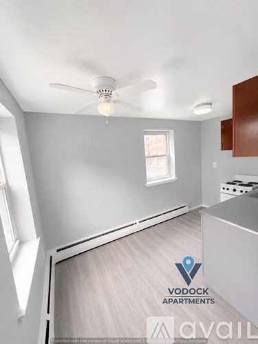 A Vodock Apartments kitchen with a fan and a window.