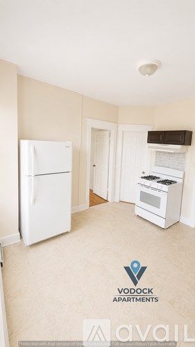 A kitchen with a fridge and stove in a Vodock Apartments unit.