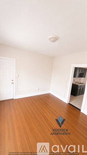 A room with a logo of Vodock Apartments on the floor.