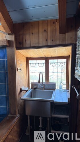A small kitchen with a sink and a window.