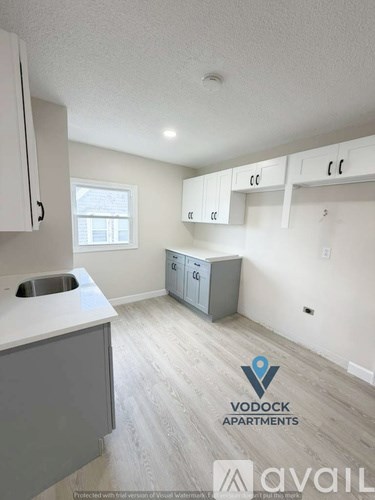 A kitchen with Vodock Apartments logo.