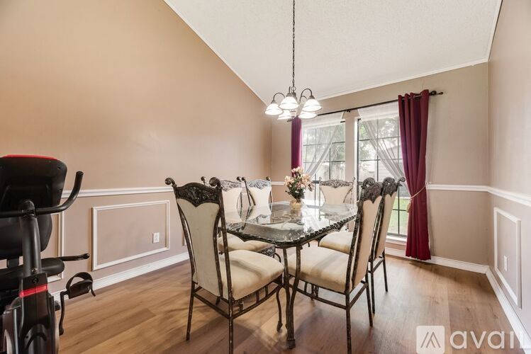 A dining room with a table set for four.
