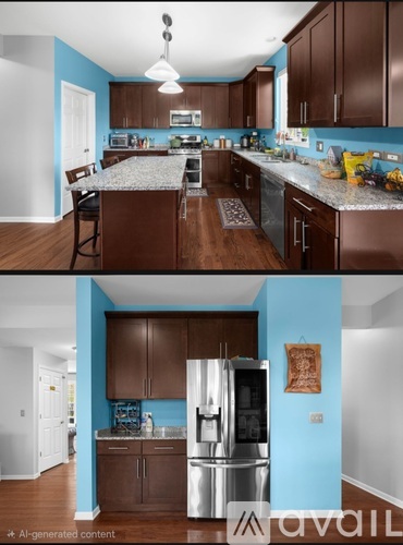 A kitchen with brown cabinets and a blue wall.