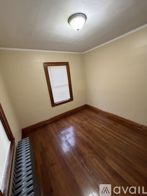 A room with wooden floors and a window.