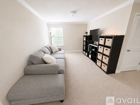 A living room with a grey sofa and a television.
