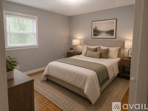 A bedroom with a large bed and a painting on the wall.