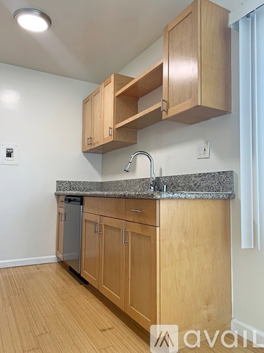 A kitchen with wooden cabinets and granite countertops.