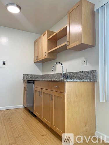 A kitchen with wooden cabinets and granite countertops.