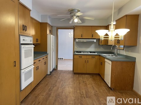 A kitchen with wooden cabinets and a white refrigerator.
