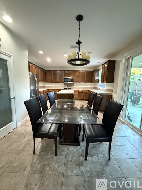 A modern dining room with a large table and chairs.
