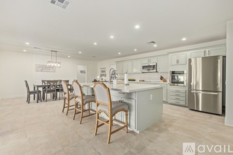 A kitchen with a dining table and chairs.
