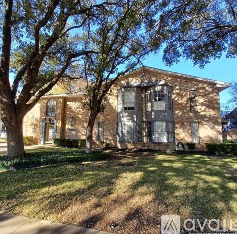A house with a tree in front of it.