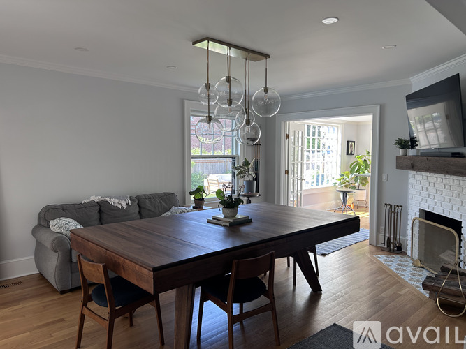 A dining room with a wooden table and chairs.