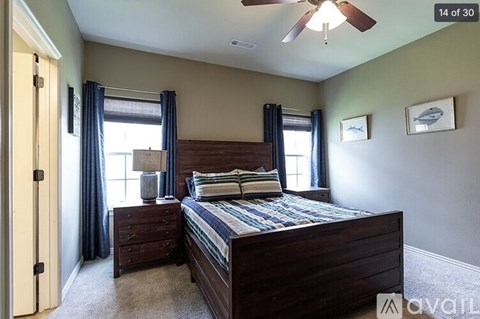 A bedroom with a bed, dresser, and window.