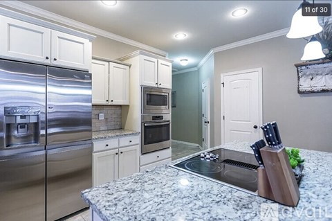 A kitchen with granite countertops and stainless steel appliances.