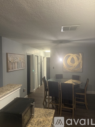 A dining room with a table set for four.