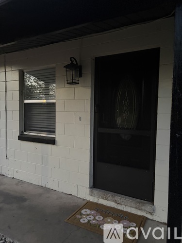 A house entrance with a mat that says "welcome" on it.