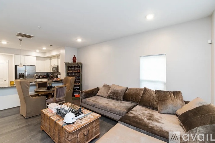 A modern living room with a brown sofa and a wooden coffee table.