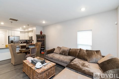 A modern living room with a brown sofa and a wooden coffee table.