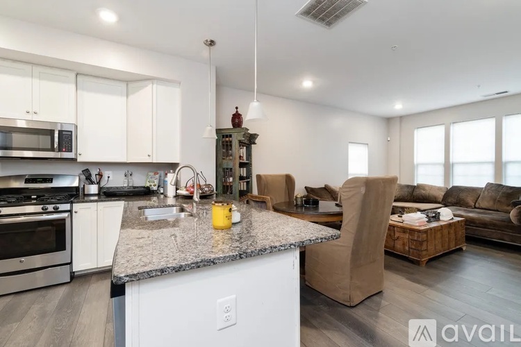A kitchen with granite countertops and stainless steel appliances.