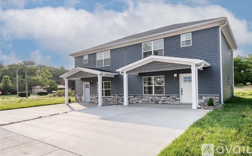A two-story house with a garage on the ground floor.