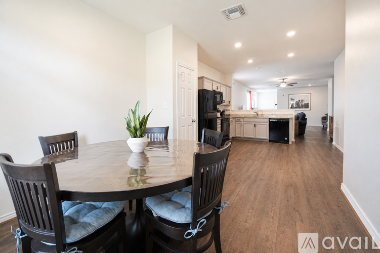 A dining room with a round table and chairs.