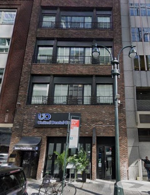 A brown building with a United Dental Care sign on the front.