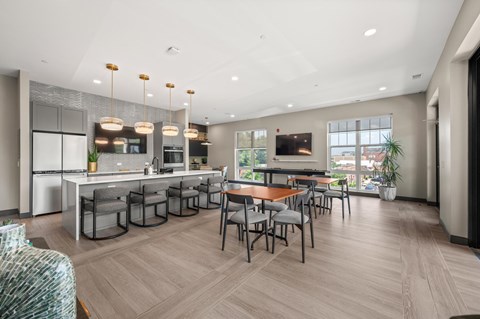 A modern kitchen with a dining table and chairs.