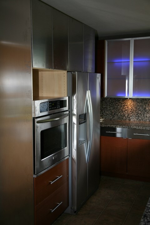 A kitchen with a stainless steel refrigerator and oven.