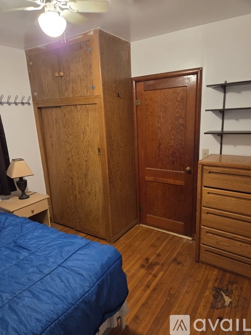 A bedroom with a bed and a wooden door.