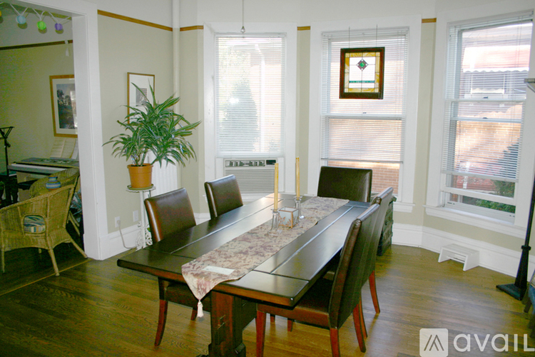 A dining room with a long table and chairs.