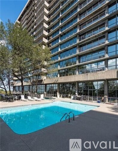 A large building with a pool in front of it.