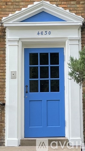 A blue door with a white frame and a number 4630 above it.