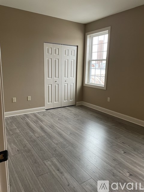 A room with a white door and a window with a white frame.