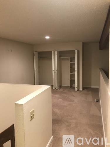 A room with a white wall and a light switch.