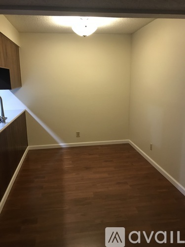 A room with wooden flooring and a light on the ceiling.