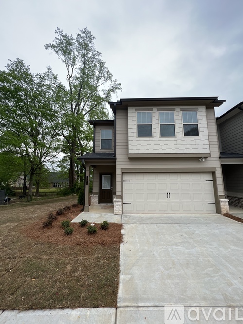 A two-story house with a garage is for sale.