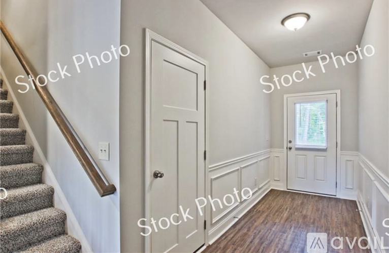 A room with a staircase and a door.