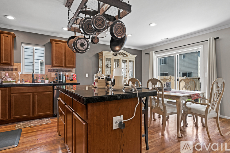 A kitchen with wooden cabinets and a black countertop.