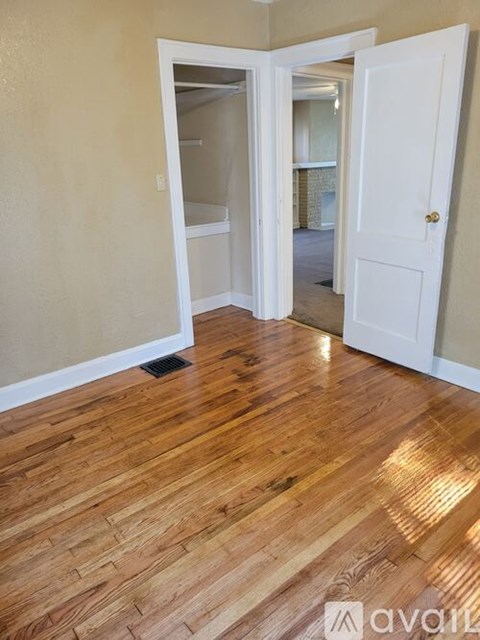 A room with wooden floors and white doors.