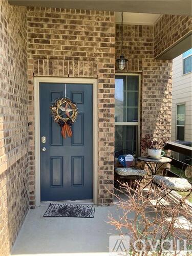 A blue door with a wreath on it.