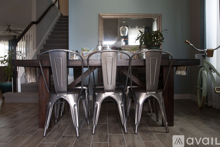 A dining room with a table and chairs.