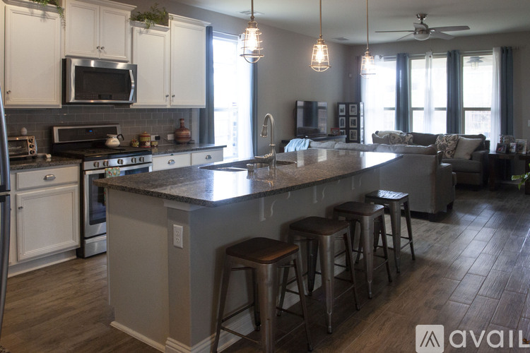 A kitchen with a bar area and a ceiling fan.