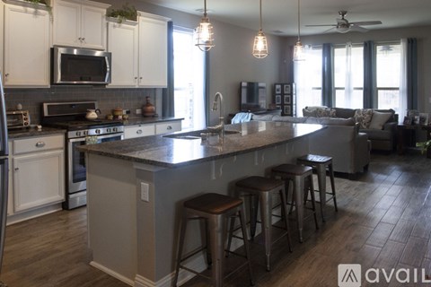 A kitchen with a bar area and a ceiling fan.