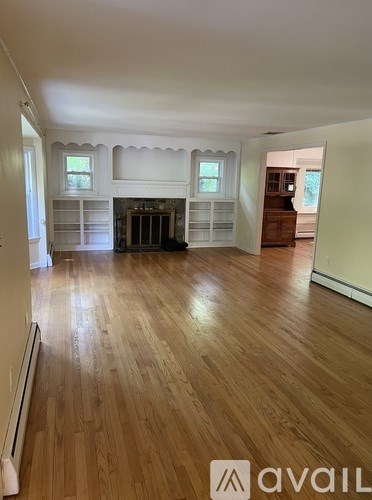 A dining room with a wooden table and chairs.