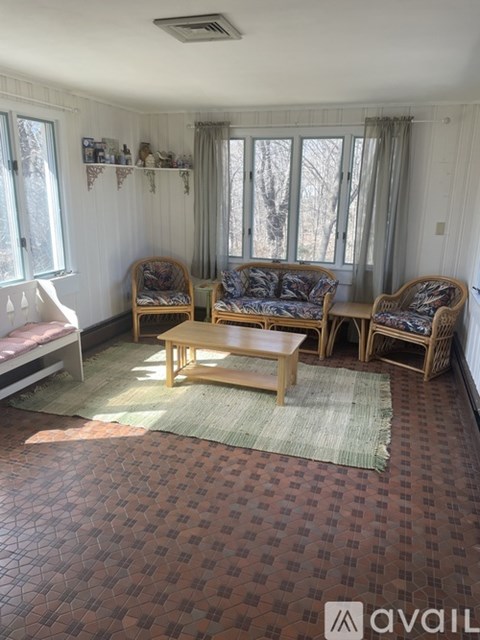 A living room with a checkered floor and a sofa set.