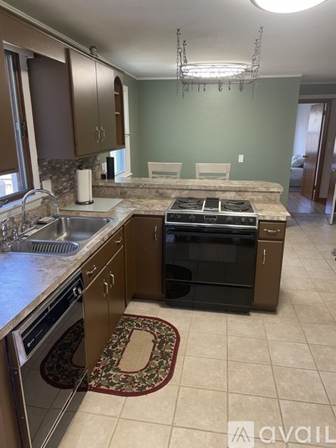 A kitchen with a black oven and a sink.